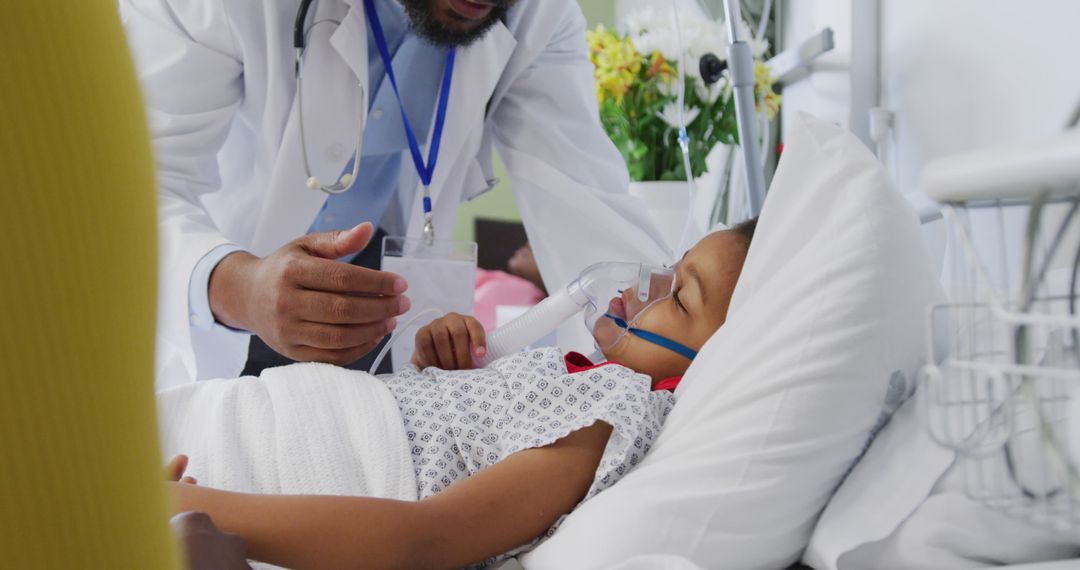 Doctor caring for a young child patient in a hospital bed